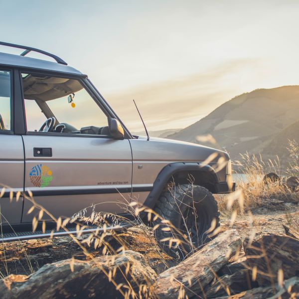 Land Rover through vineyards with Douro River view